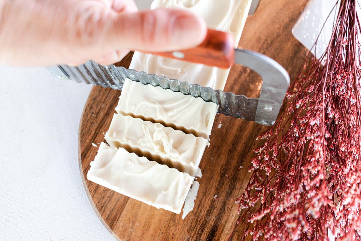 Cutting shea butter soap into soap bars. 