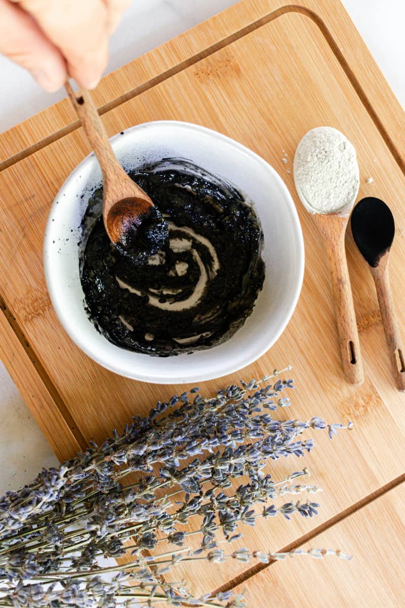 Stirring a homemade armpit detox up with a wooden spoon.