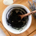 Stirring up bentonite clay and activated charcoal to make an armpit deodorizer.