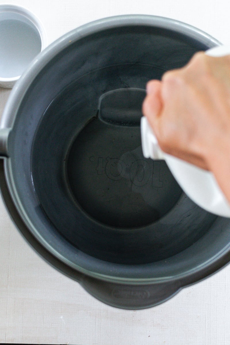 Pouring vinegar into a bowl. 