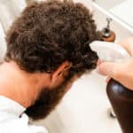 Spraying grey hairs with black tea.