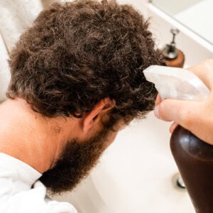 Spraying grey hairs with black tea.