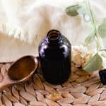 Rosemary oil for hair in a glass jar for storage.