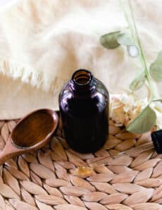 Rosemary oil for hair in a glass jar for storage.