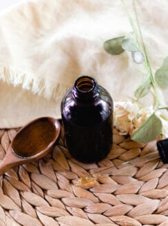 Rosemary oil for hair in a glass jar for storage.