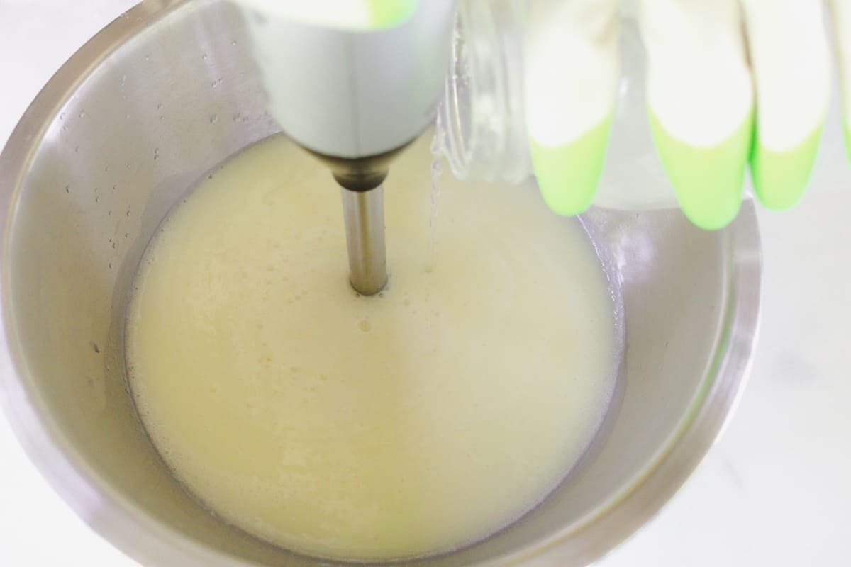 Mixing the soap with an immersion blender.