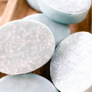 Sea salt soap bars drying on a wooden drying rack.