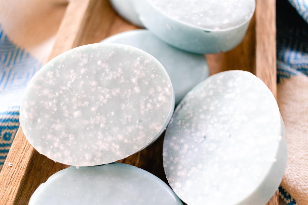 Oval shaped sea salt soap bars on a wooden rack.