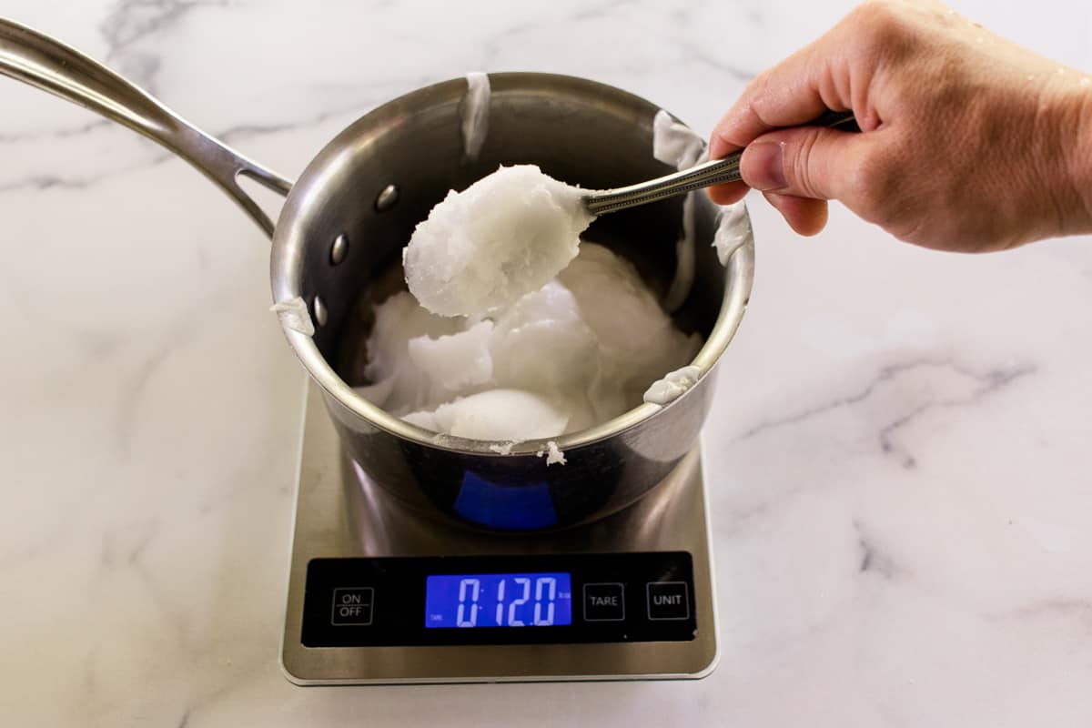 Measuring out the coconut oil for the soap.