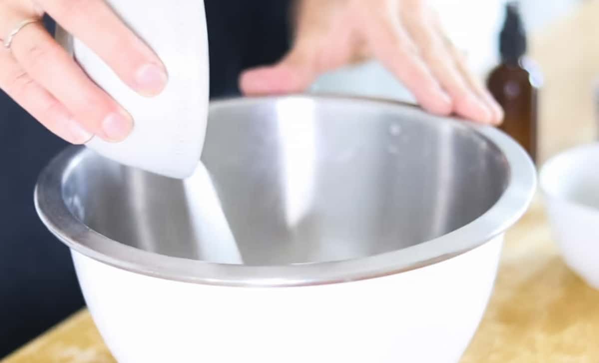 Adding citric acid and baking soda to a mixing bowl.
