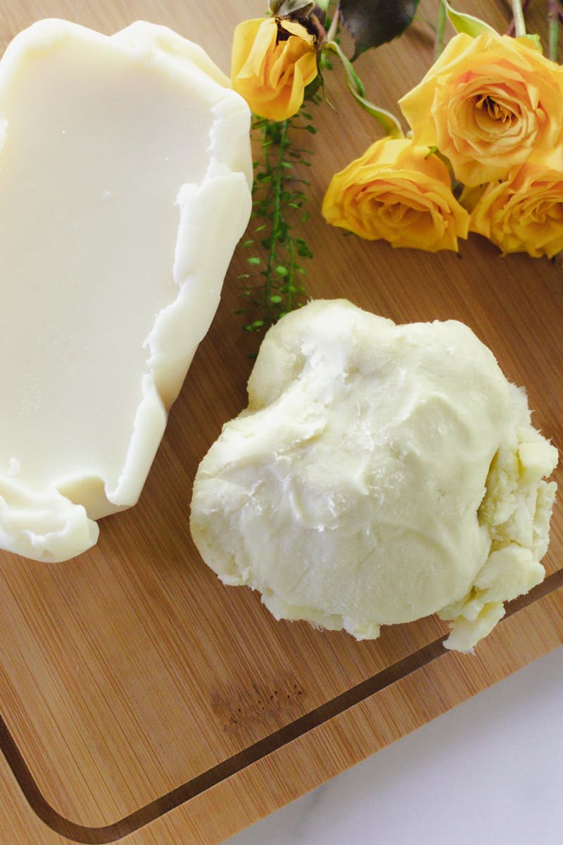 Mango butter and shea butter on a wooden board. 