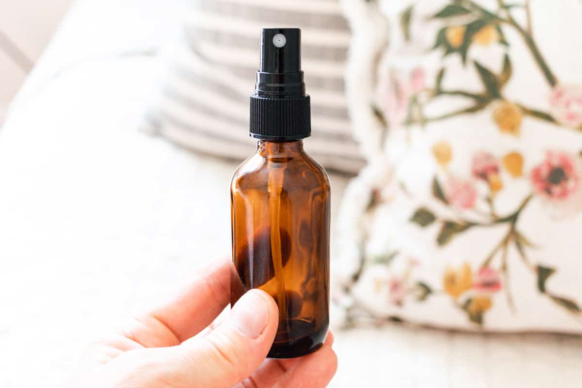 A bottle of body mist in an amber spray bottle.