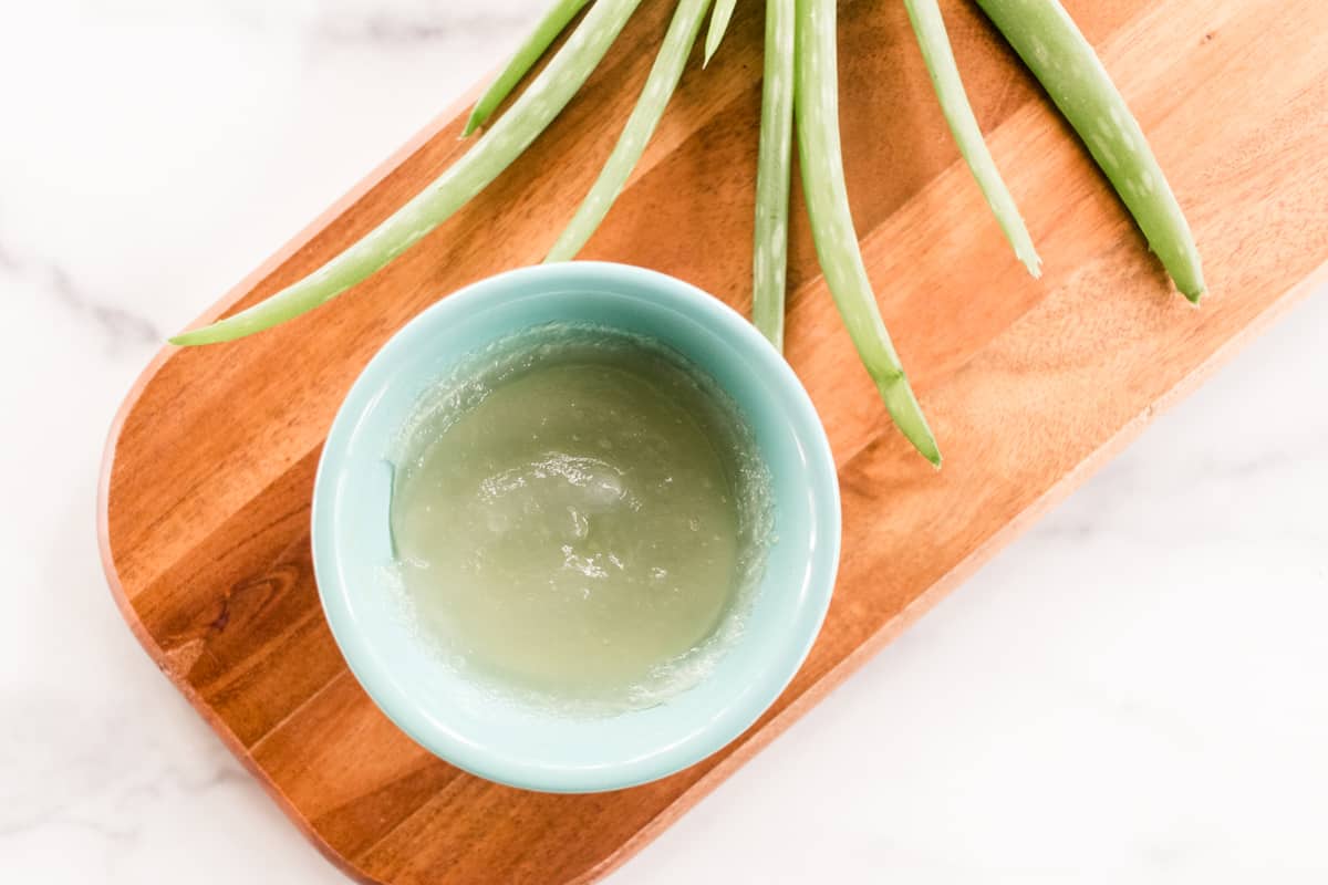 Aloe Vera gel and stems on a wooden board. 