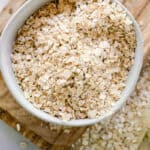 A bowl of oatmeal ready to be ground of for colloidal oatmeal for the skin.