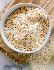 A bowl of oatmeal ready to be ground of for colloidal oatmeal for the skin.