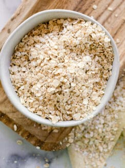 A bowl of oatmeal ready to be ground of for colloidal oatmeal for the skin.