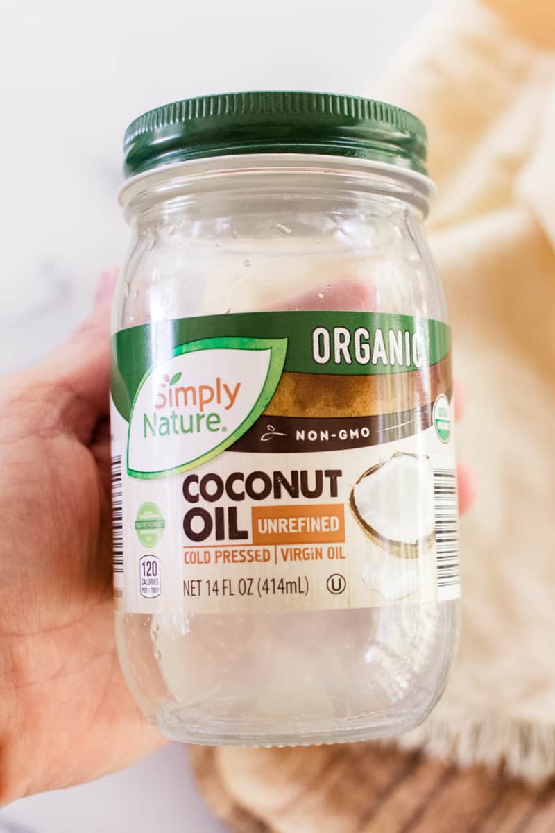 Holding a container of coconut oil that is organic.