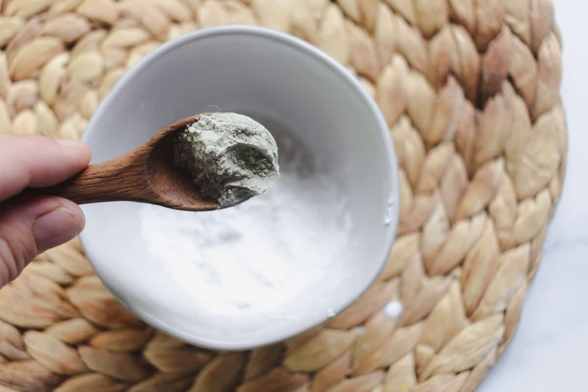 Adding bentonite clay to the bowl.