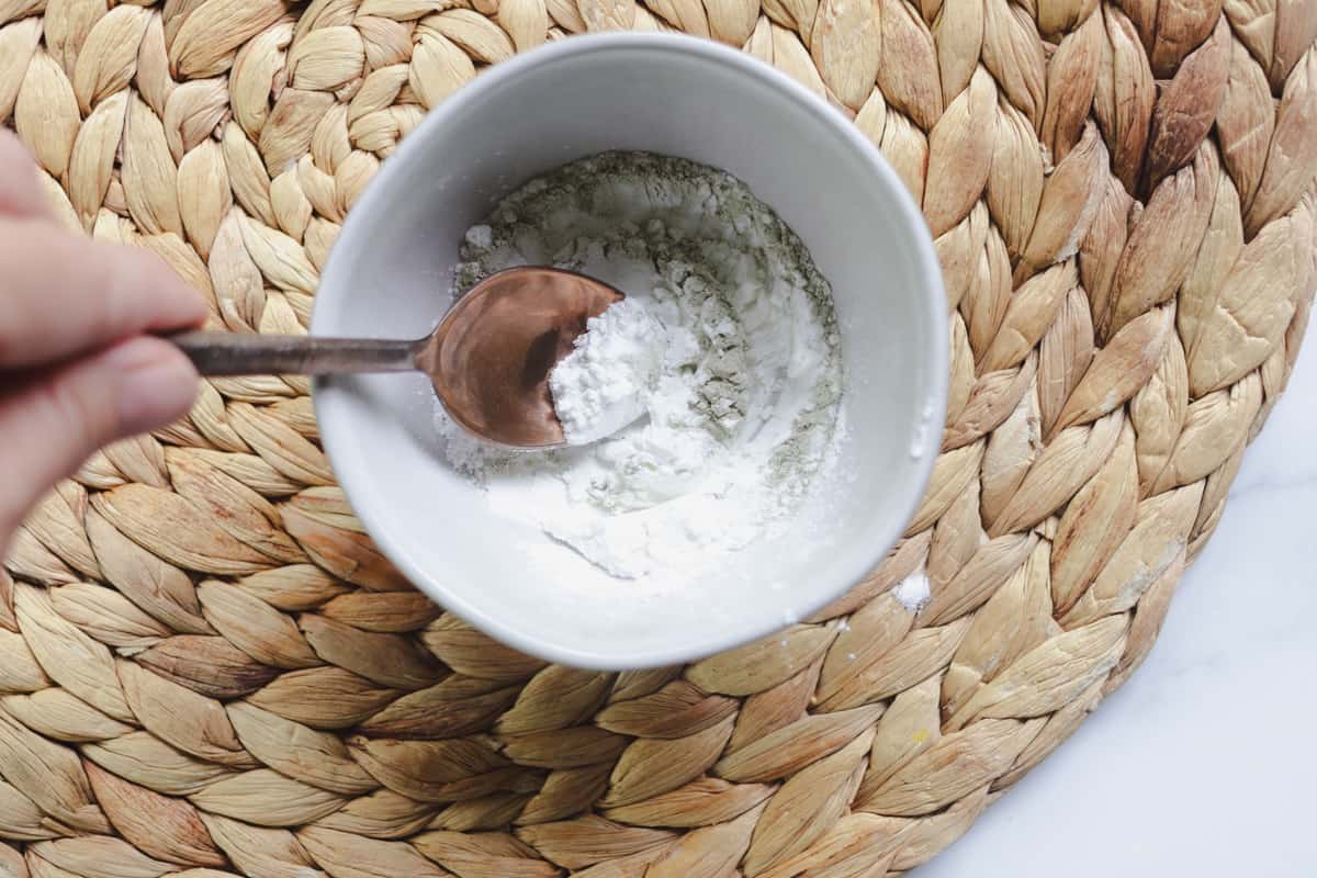 Stirring the dry shampoo ingredients together.