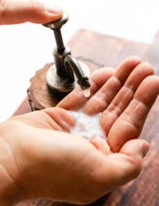 Squirting liquid hand soap onto my hand.