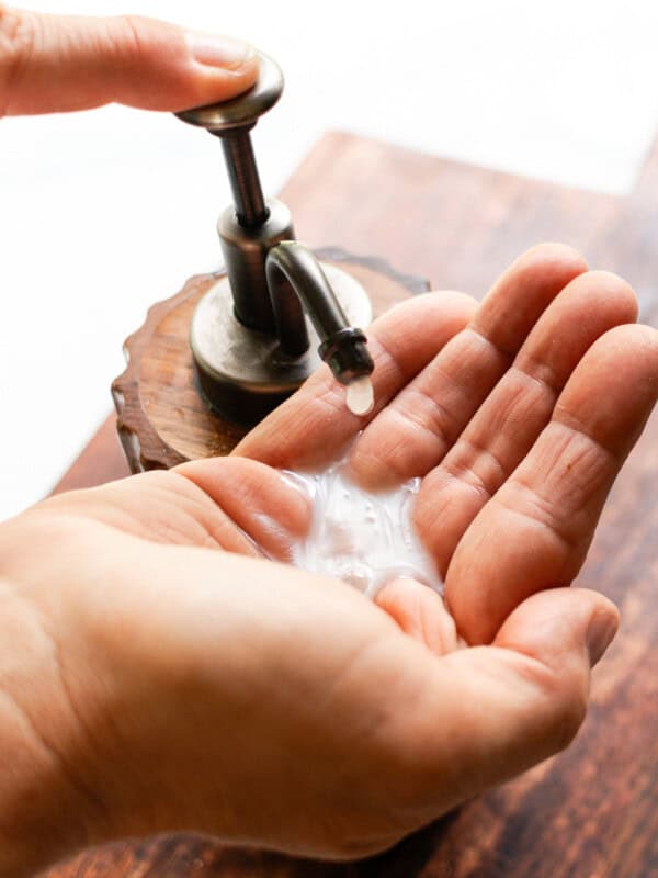 Squirting liquid hand soap onto my hand.