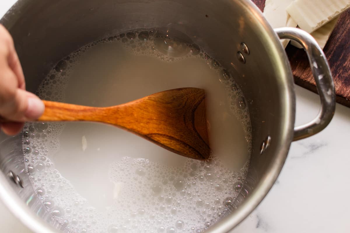 Stirring the soap after it has cooled.