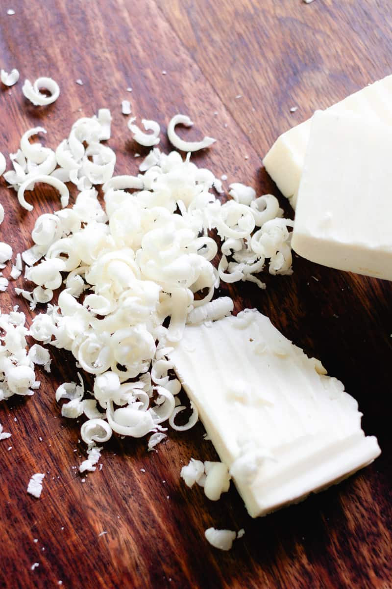 A shredded soap bar on a wooden board.