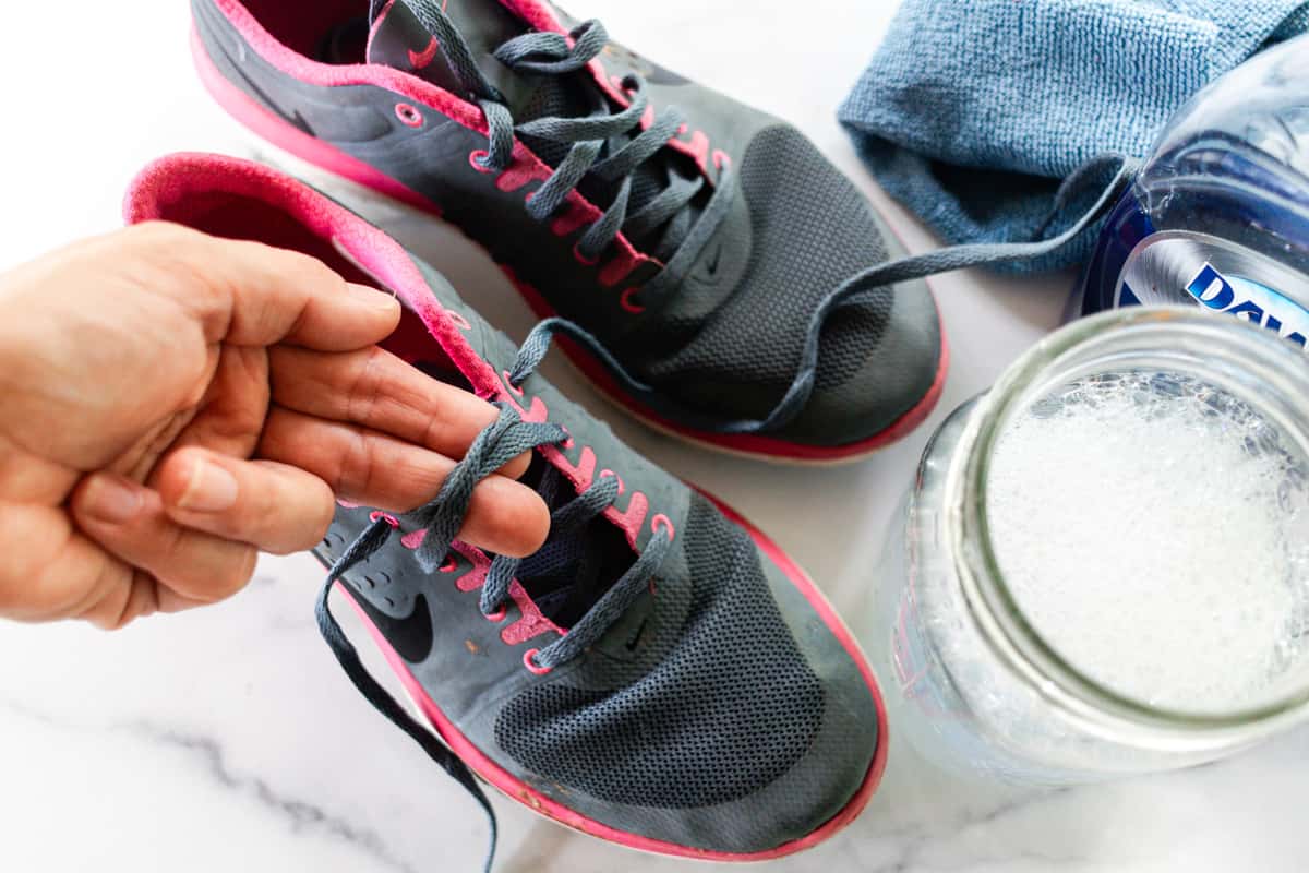 Removing the shoe laces from mesh shoes.