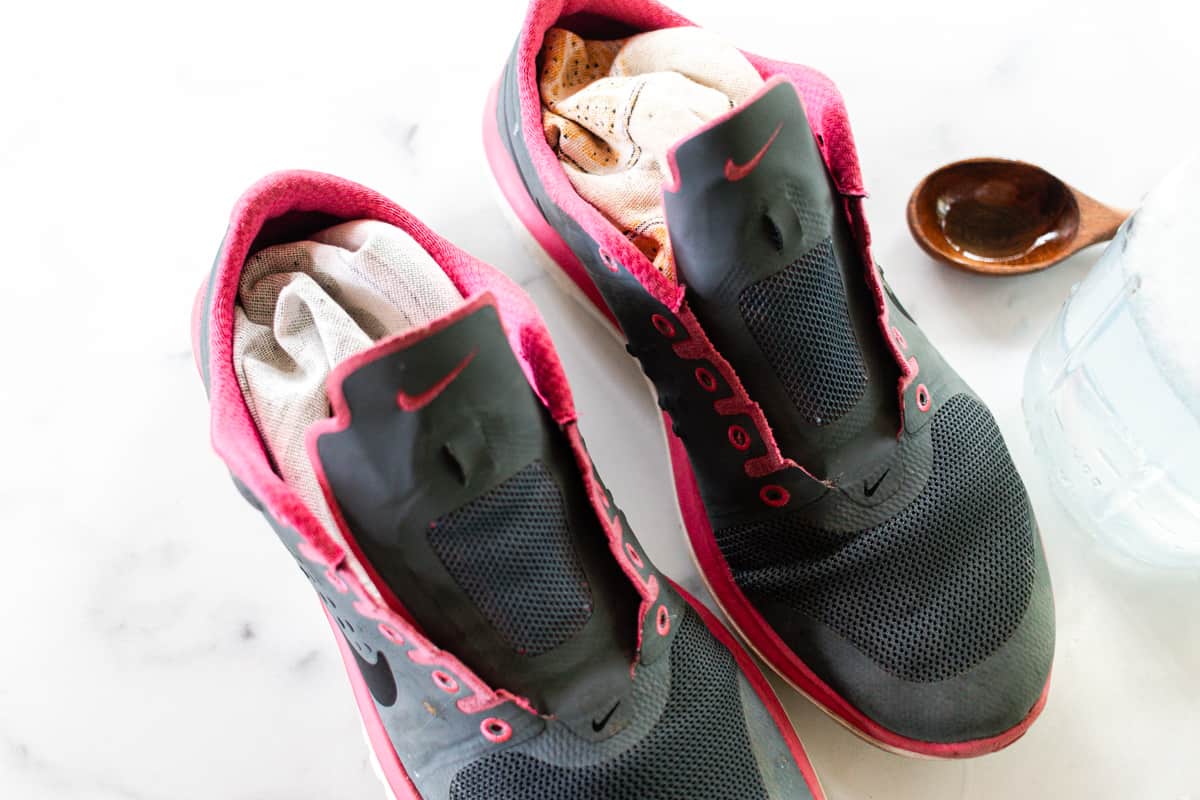 Stuffing mesh running shoes with newspapers.