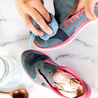 Cleaning mesh shoes with soap and water.