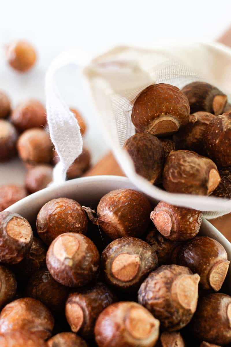 Soap nuts in a bowl and muslim bag to be used for the hair.