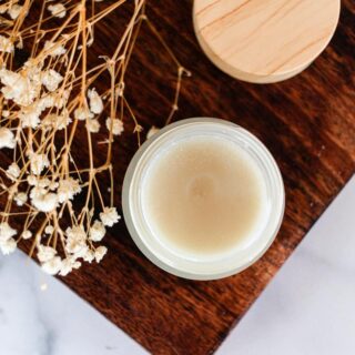 A homemade cleansing balm in a small glass container.