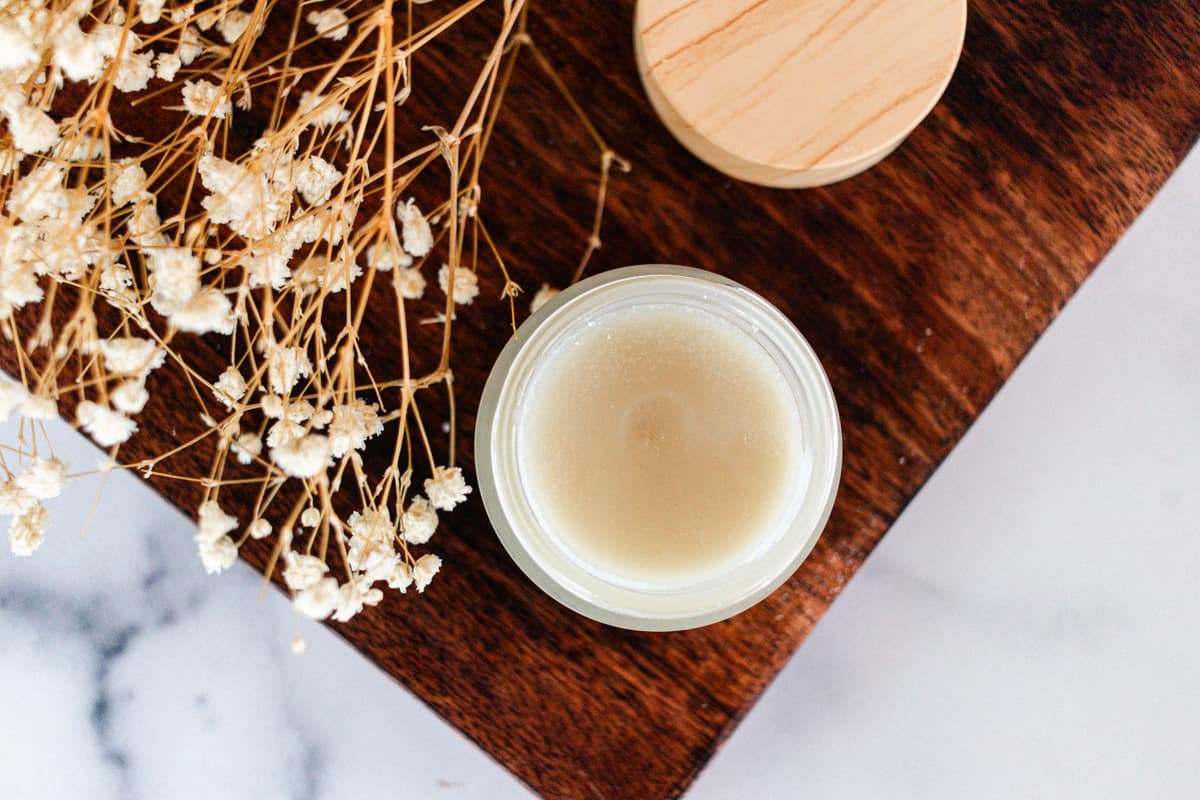 A homemade cleansing balm in a small glass container.