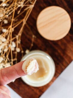 Applying a diy cleansing balm with my fingertips.