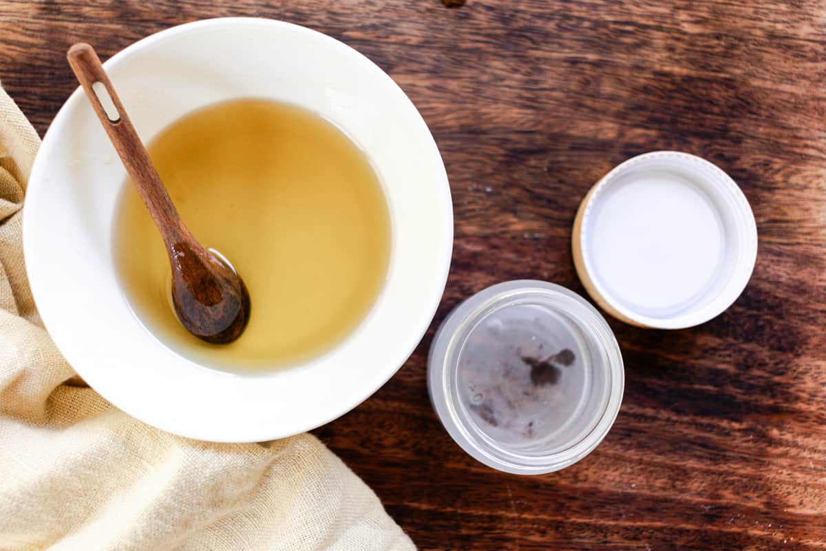 Transferring the melted ingredients to a glass bowl.