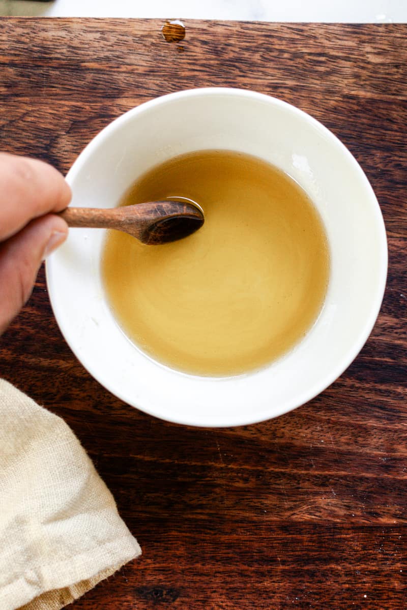 Stirring the melted cleansing balm ingredients.