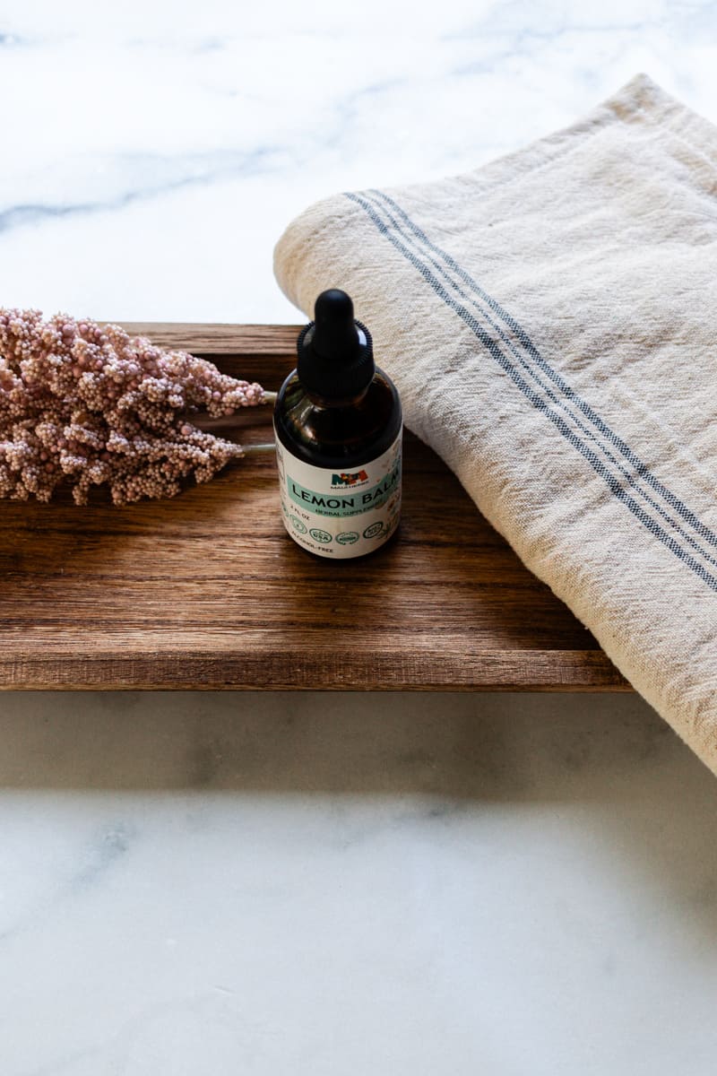 A small bottle of lemon balm oil with a dropper top. 