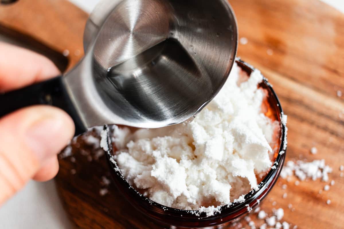 Adding the oils to the coconut powder.