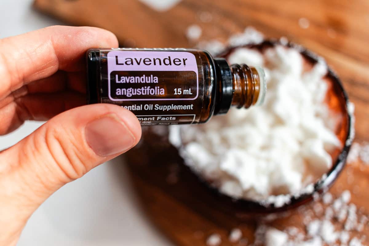 Adding lavender essential oil to the mixture.
