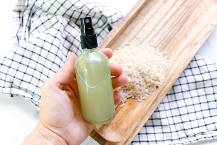 A homemade rice water for hair spray in a clear bottle.