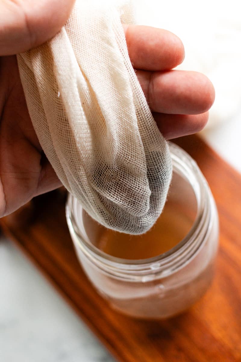 Straining the soap through a cloth.