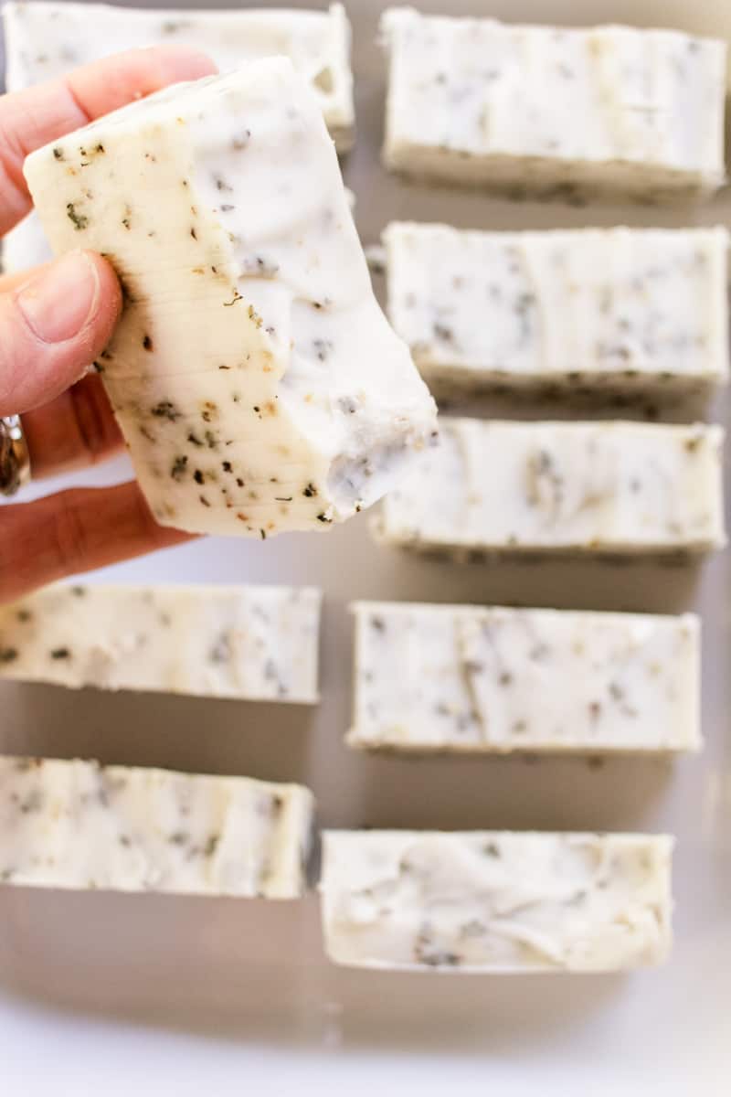 Holding up a herbal soap bar after it has fully cured.