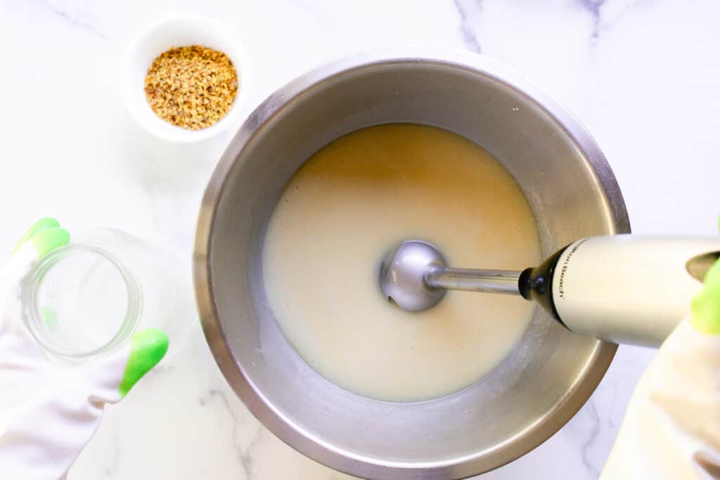 Mixing the soap with an immersion blender.