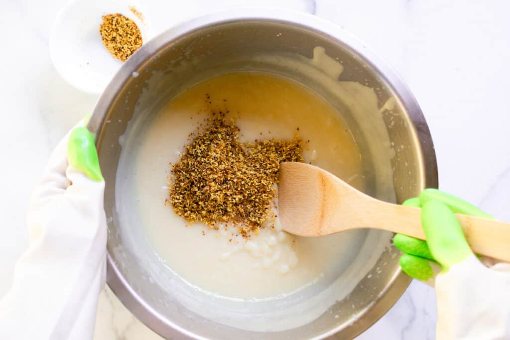 Stirring the dried flowers into the soap after it has come to a light trace.