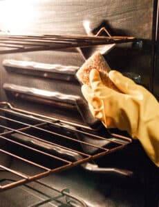 Scrubbing an oven after the grease has been loosened up with steam.