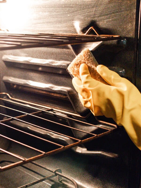 Scrubbing an oven after the grease has been loosened up with steam.