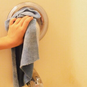 Wiping the calsium buildup off the shower handle with vinegar and a scrubbing rag.