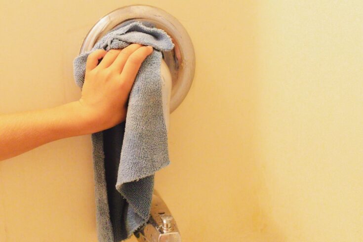 Wiping the calsium buildup off the shower handle with vinegar and a scrubbing rag.