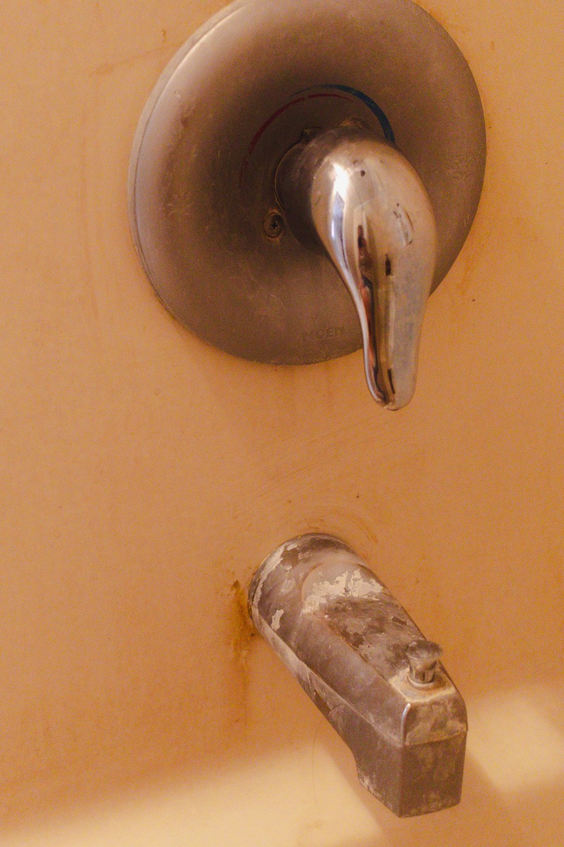 Calcium buildup on the shower head and faucet.