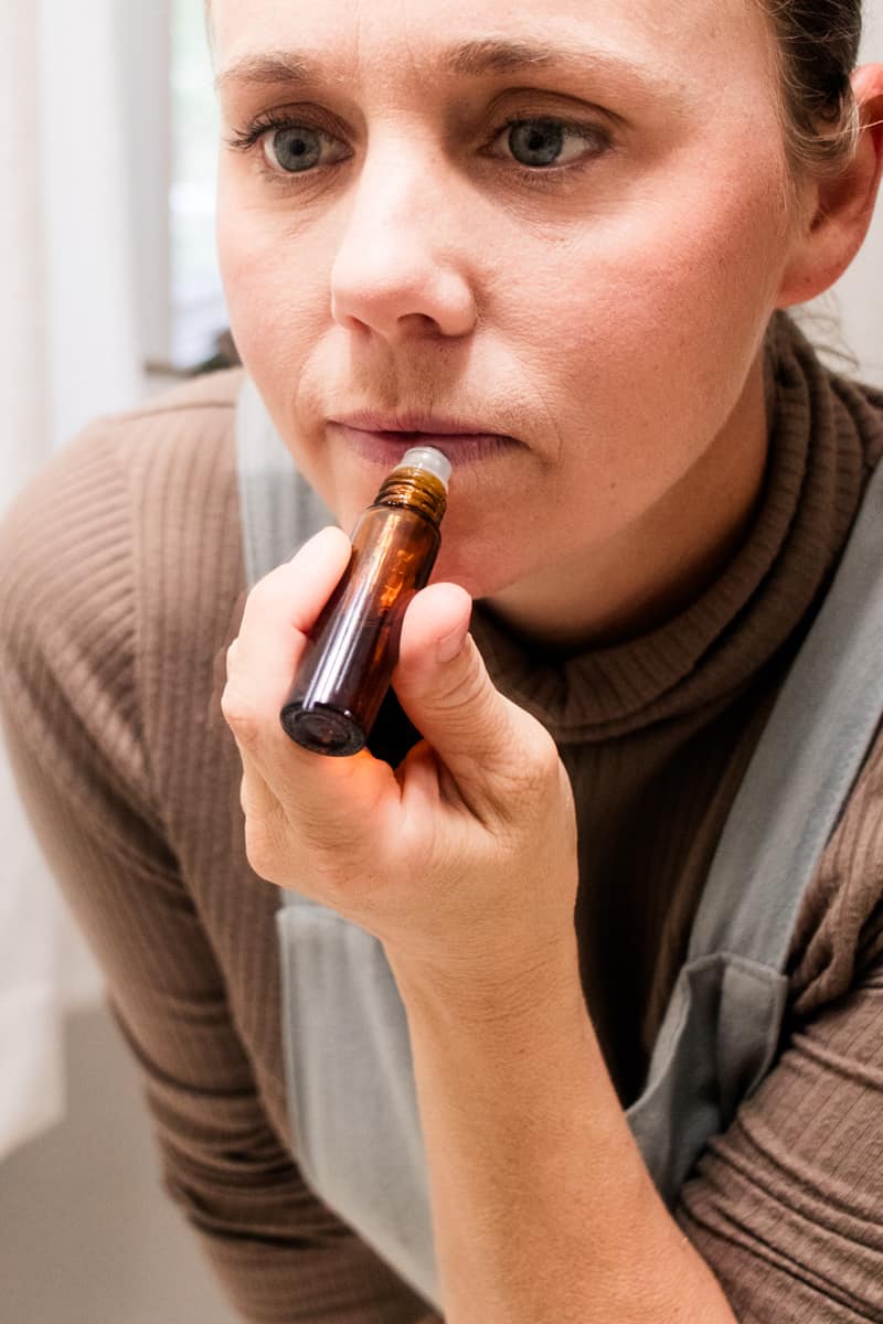 Using the roller ball top to apply the lip oil to my dry lips. 